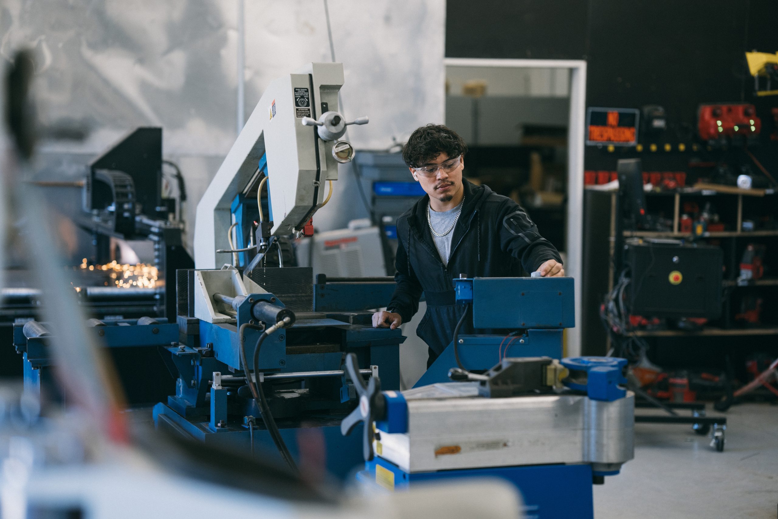 Engineer operating metal engraver in factory